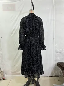 Close-up of French polka dot chiffon dress featuring high collar and ruffled cuffs detail