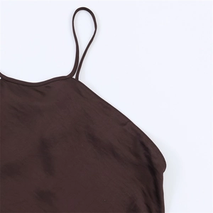 Close-up of thin shoulder straps and satin fabric texture on a brown dress