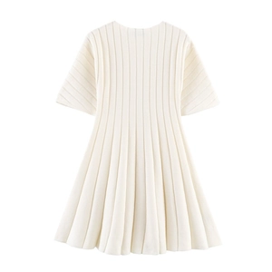 Detail of white short sleeve knit dress showing vertical ribbed texture and crew neck