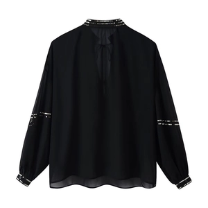 Women's black loose chiffon blouse with sparkling sequins and tie-neck detail