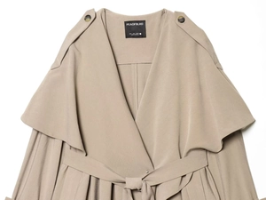 Detail of khaki trench coat featuring shoulder epaulettes and a waist tie belt