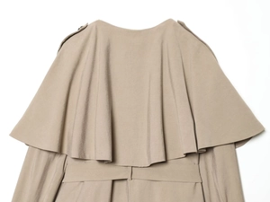 Detail view of the elegant khaki trench coat back flap and smooth draped fabric texture