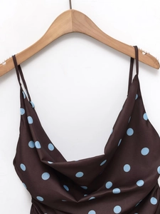 Close-up of brown satin camisole featuring blue polka dots and soft draped neckline