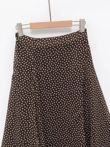 Detail of a brown polka dot midi skirt with lightweight ruffled chiffon texture