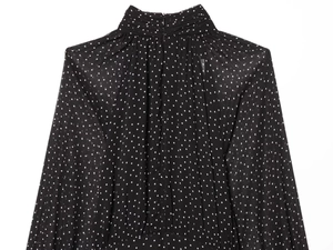 Detail of high neck pleated chiffon top with white polka dots and back zipper closure