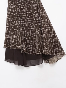 Detail of dark brown polka dot skirt with lightweight layered chiffon fabric