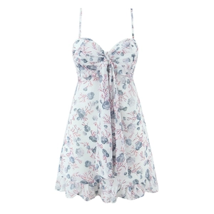 Detail of slim fit mini dress featuring sea shells and coral prints with a bow
