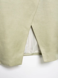 Detail of light green blazer rear vent with premium striped lining and fine stitching
