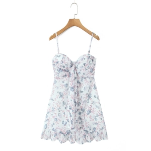 Detail of floral mini dress with seashell print and decorative bow on the neckline