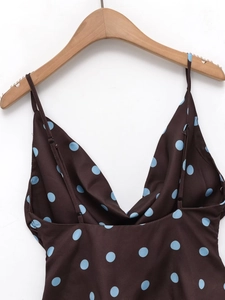 Close-up of brown and blue polka dot camisole with deep V-neck and thin straps