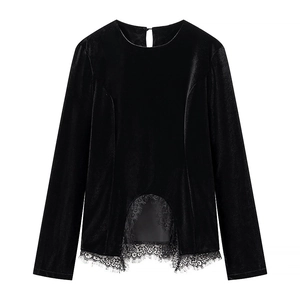 Detailed close-up of long sleeve velvet top featuring elegant black lace trim at the hem