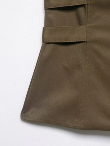 Detailed view of the khaki twill fabric and decorative waist belt stitching on vest