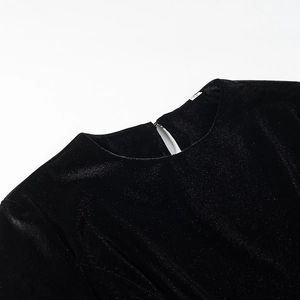 Detail of crew neckline with rear keyhole button and size M label on black velvet top