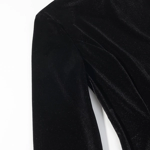 Macro detail of the premium black velvet fabric texture on a slim fit long sleeve top