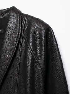 Detail showing high-quality black faux leather texture and stitching on the jacket collar