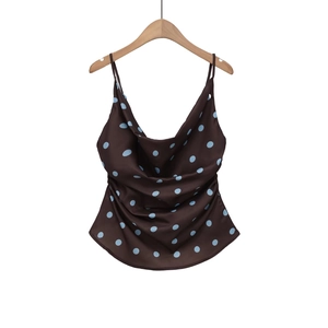 Retro brown satin camisole with blue polka dots and thin straps on wooden hanger