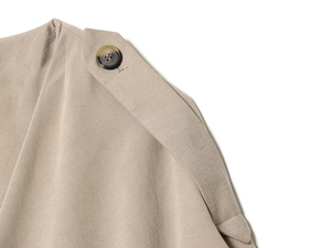 Detail shot of khaki trench coat epaulette with high-quality twill fabric and button
