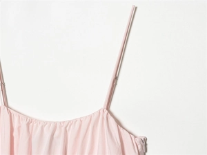 Detail shot of pale pink dress featuring thin spaghetti straps and a side hidden zipper