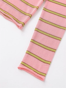 Detail of pink and green striped knit sweater showing rolled hem and sleeve cuff texture
