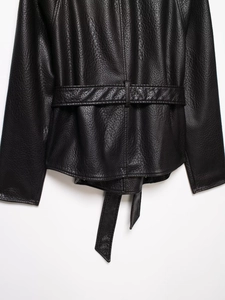 Macro shot of black pebbled leather jacket back detail with adjustable waist belt buckle