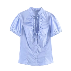 Light blue short sleeve puff blouse with ruffled neckline and bow tie detailing