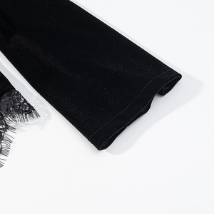 Detail view of black velvet sleeve cuffs featuring delicate eyelash lace trim for women