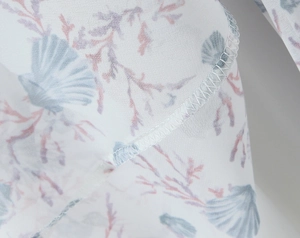 Detailed view of floral chiffon fabric with nautical seashell and coral print patterns