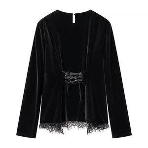 Detail of black velvet long sleeve top with waist lace trim and lace-up design