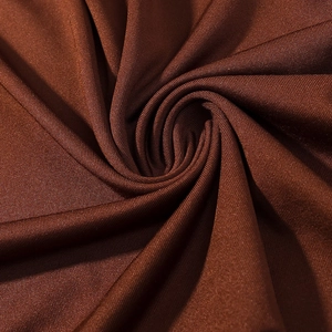 Detailed close-up of dark brown stretch knit fabric with glossy finish and soft drape
