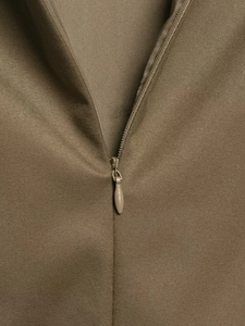 Macro detail of high-quality khaki twill fabric with matching invisible zipper closure