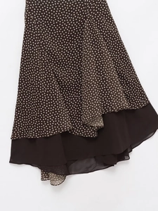 Detailed view of women's polka dot skirt with asymmetrical layers and sheer chiffon fabric