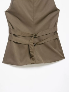 Detail view of khaki vest back featuring adjustable dual straps with dark brown buttons