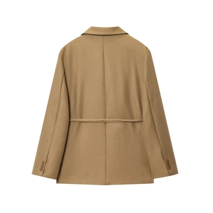 Detail view of the tan linen blazer back with waist strap and sleeve buttons
