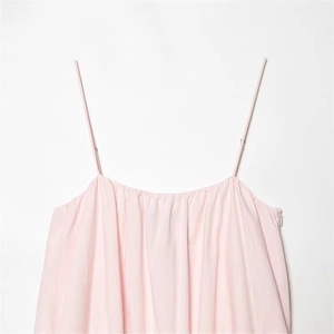Pink spaghetti strap balloon dress with pleated neckline and adjustable straps