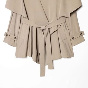 Women's French style khaki trench coat with large lapels and a belted waist design