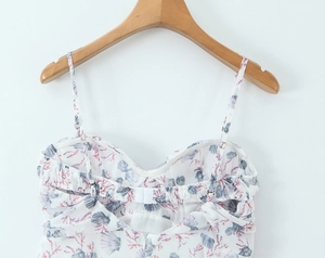 Detail of white camisole top featuring blue shells and pink coral ocean print patterns