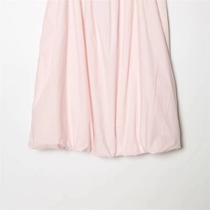 Pale pink bubble hem dress with elegant pleats and high-quality satin sheen finish