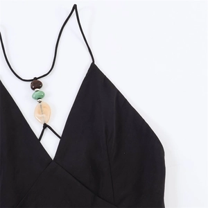 Close-up of black halter dress with colorful beads and silver metal separators