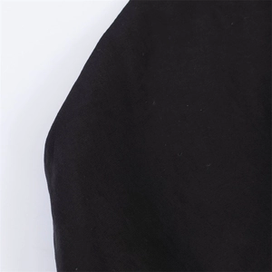 Detailed macro shot of high-quality black textile fabric with clear weaving patterns