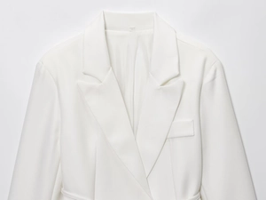 Detail of peak lapel and fabric texture on white linen blend blazer for women