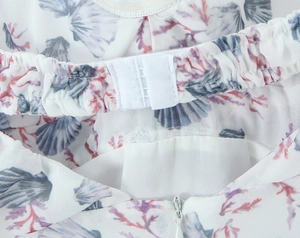 Detail view of floral shell print dress with back hook-and-eye closure and invisible zipper