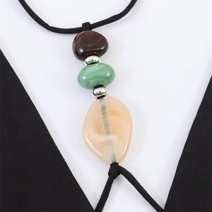 Detail of bohemian necklace with irregular colorful resin beads and silver spacers