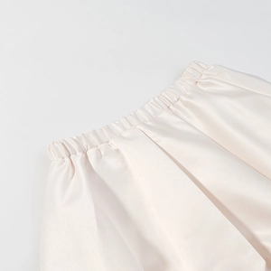 Vue macro détaillée de la taille élastique sur cet ensemble de jupe en satin soyeux