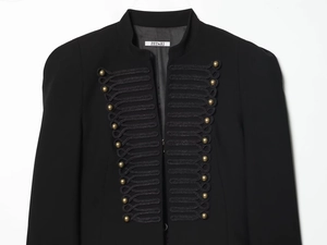 Detail of hussar jacket featuring black braided trim and gold military buttons