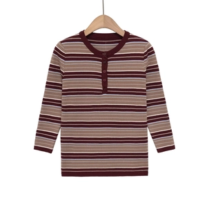 Detail of slim fit striped knit shirt with henley neck buttons and ribbed texture