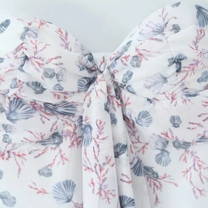 Slim fit floral summer dress with ocean shell print and central twist knot detail