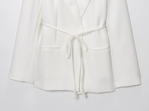 Detailed macro view of the classic notched lapel on a white linen blend blazer
