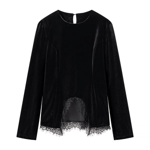Detail of black velvet long sleeve top showing lace hem and unique cutout design