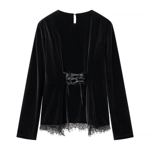 Detailed back view of velvet top with criss-cross lace-up ties and eyelash lace trim