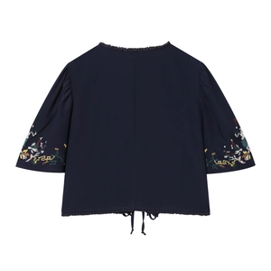 Detail of floral embroidery on sleeve and drawstring hem of navy crop blouse
